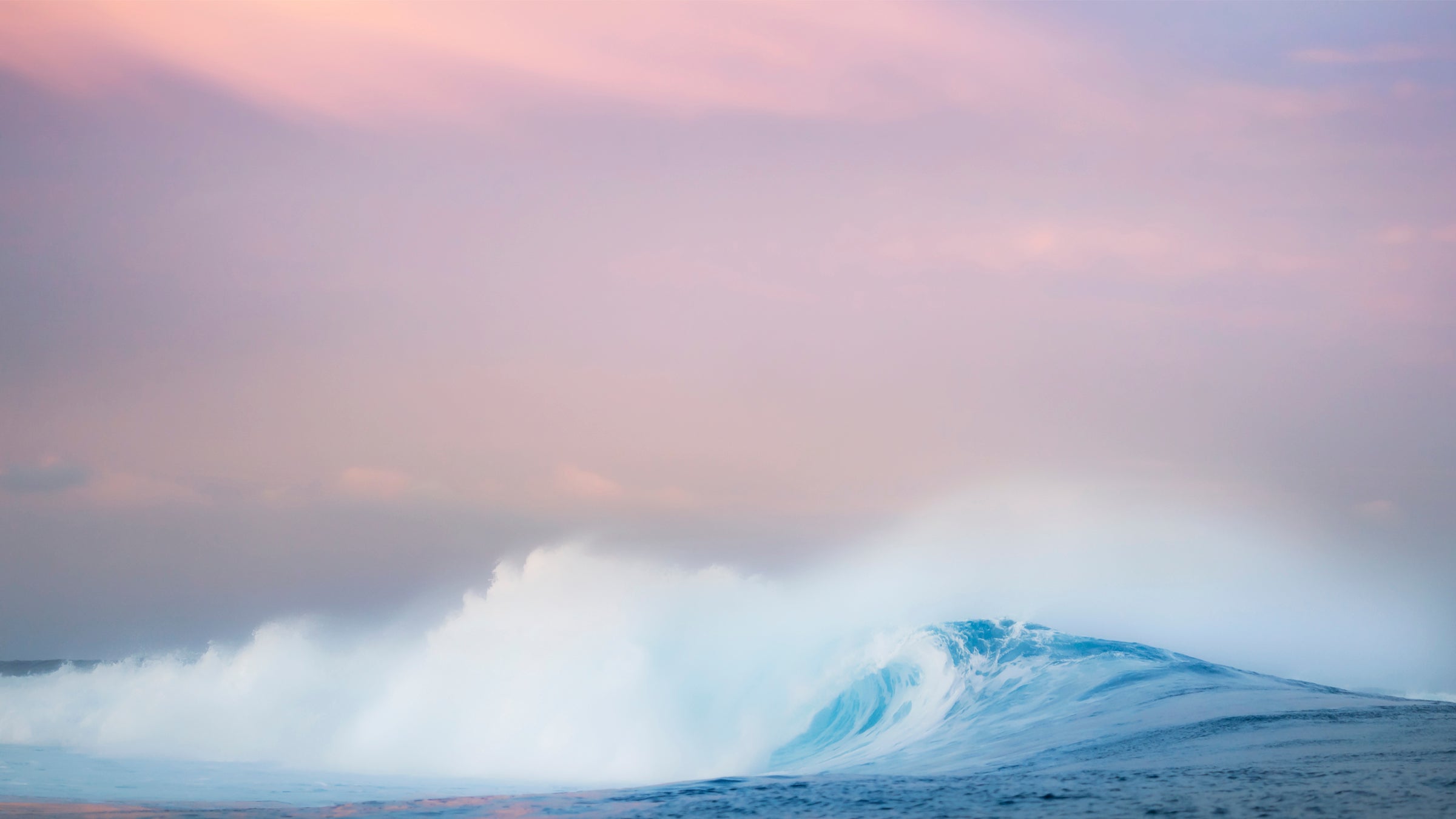 Snowy mountain landscape with a pink and purple sky