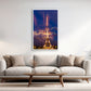 Modern living room with a white sofa, coffee table, and a framed photo of the Eiffel Tour. 