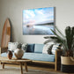 Modern living room with a piece of Bo Bridges fine art displaying a scenic image of the Manhattan Beach Pier, sofa, coffee table, and decorative items.