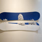 Two snowboards with a winter landscape design on a plain background