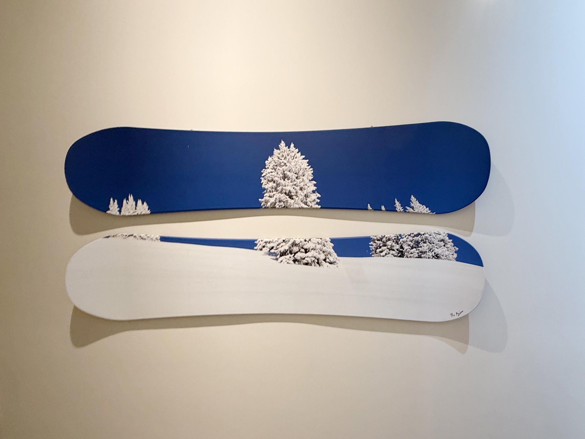 Two snowboards with a winter landscape design on a plain background